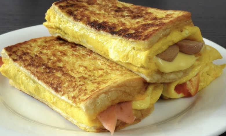 Photo of Gebackenes Toastsandwich mit Eiern, Käse und Bratwurst oder Schinken